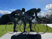 A statue of a trio of cyclists in front of the Olympic museum in Lausanne