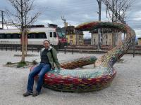 Marco sits on the tiled snake sculpture at Platforme 10 in Lausanne