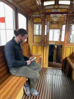 Marco reads on the old-timey tram