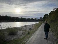 Kath walking along the Rhine river in Basel near sunset