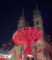 The flying swings ride in front of the...l Münster at the Basler Herbstmesse