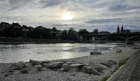 The sun peeks through over the Rhine river in Basel