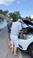Dad jump-starts the car with a super-booster battery