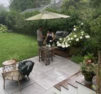 Kate and Ömer grilling chicken in a downpour