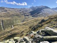 The Furkastrasse peeks out of the rocks and grass