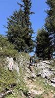 Marco stands in the gap at the top of the Warmtobel