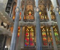 The warm, rosy glow of red and orange stained glass in the Sagrada Familia