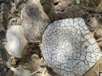Tilework embedded in the rough rock near the house in Park Güell
