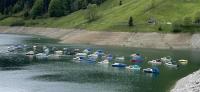 Closeup of boats arrayed on a sorely depleted Wägitalersee