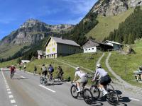 Cyclists heading up and down the Klausenpass at Urnerboden