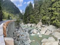 Gorgeous wooden guardrail along the river near Sufers